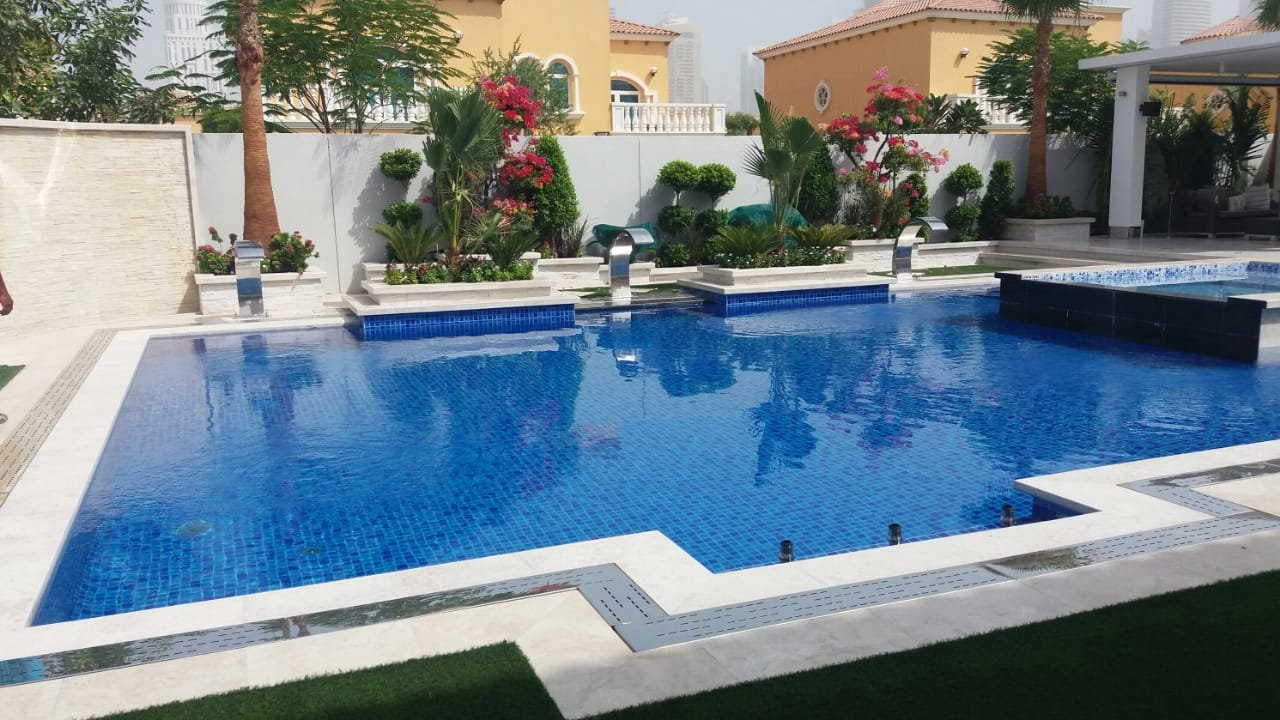 Pool Tech pool surrounded by a landscaped villa garden